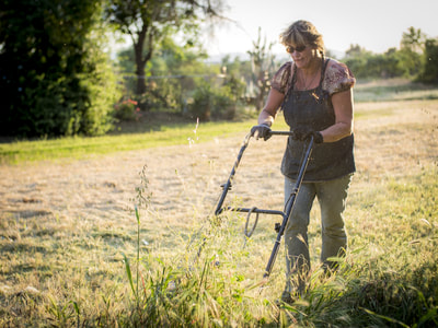 Mowing a field.  A woman who can.